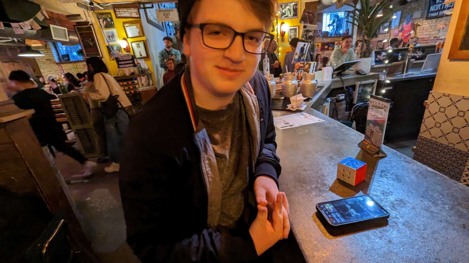 Tim at a bar in Toronto with a Rubik's cube